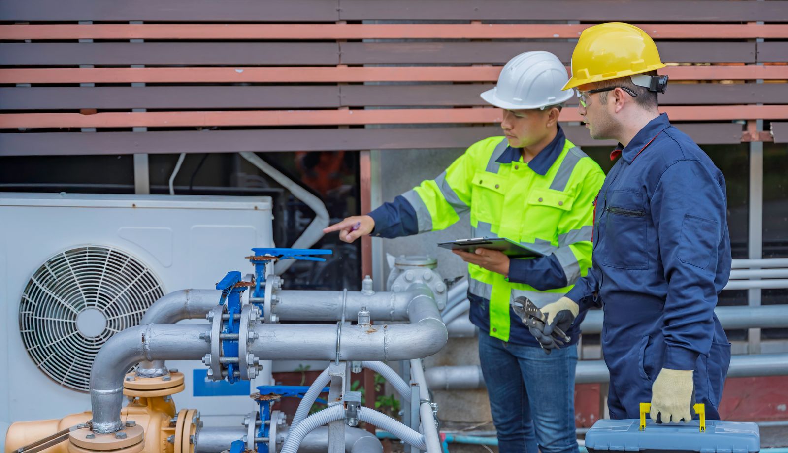 Engineers surveying pipework and plant on site